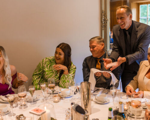 Comedy wedding table magician cotwolds house hotel A table in hilarious fits of laughter as Brett Sirrell entertains with his close up magic at the cotswolds house hotel
