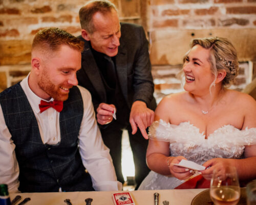 Copyright Dearest Love- Bride and groom having fun and laughing as Brett Sirrell entertains them with amazing magic