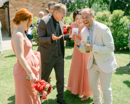 Drinks Reception Wedding magic fun Barns and Yard Wedding guests and bridesmaids react to the magic of Brett Sirrell, at a Worcestershire venue, Barns and Yard, Malvern