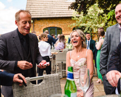 comedy wedding magic Everdon Brett Sirrell, Magic Circle magician, creating fun and laughter for guests at a corporate drinks event