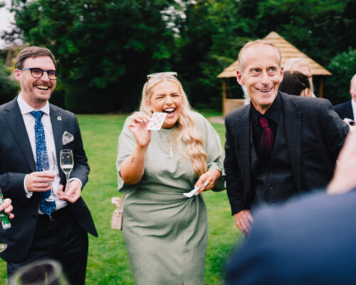 Manor house hotel Magician performing Magic and card tricks for guest in the garden of Manor House Hotel, Cotswolds.