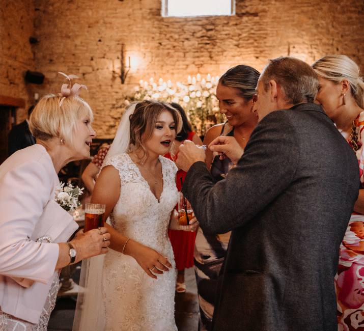 Wedding magician Brett Sirrell performing close-up magic at a Cotswolds barn reception for a bride and her wedding party