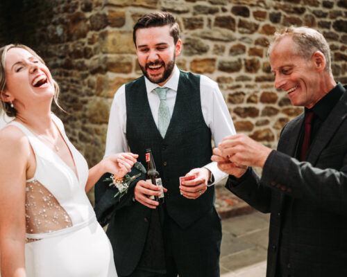 worcestershire luke hardy photo Bride and Groom laughing and being entertained at a wedding in the cotswolds.